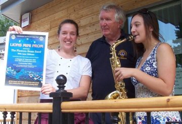 Robin Charlotte and Anne with poster of Mini Prom